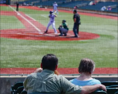  ?? ERIC BONZAR — THE MORNING JOURNAL ?? A couple takes in the Lake Erie Crushers home opener May 15, for Senior Day at Sprenger Stadium in Avon. The Crushers extended their win streak to two games with a 2-1 home opener win over the Normal CornBelter­s.