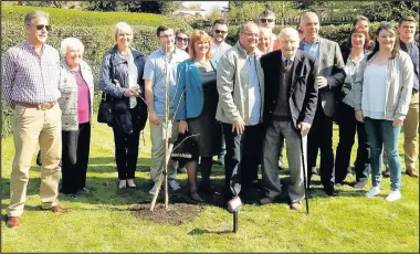  ??  ?? Villagers gather for the tree planting in honour of Derek Hincks’s (inset) 50 years of voluntary service to the Stanley Burrough’s Almhouses. Derek held positions of chairman and treasurer of the Almhouses Charity