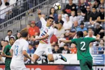  ?? MATT SLOCUM/ASSOCIATED PRESS ?? The United States’ Rubio Rubin, center, heads the ball past Bolivia’s Carlos Anez, right, as Josh Sargent looks on during an internatio­nal friendly match Monday in Chester, Pa.