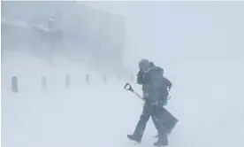  ?? Lakes, California, Saturday. Photograph: Caroline Brehman/EPA ?? A man walks as high gusts of wind blow snow around during a blizzard in Mammoth