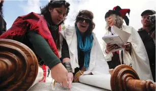  ?? (Marc Israel Sellem/The Jerusalem Post) ?? WOMEN OF the Wall members read from the Torah at the Kotel in 2013.