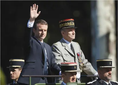  ?? (Reuters) ?? FRENCH PRESIDENT Emmanuel Macron and Chief of the Defense Staff Gen. Pierre de Villiers arrive in a command car for the Bastille Day military parade on the Champs-Elysees in Paris last week.