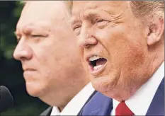  ?? Mandel Ngan / Getty Images ?? President Donald Trump on Saturday downplayed a massive cyberattac­k on U.S. government agencies, declaring it “under control” and undercutti­ng the assessment by Secretary of State Mike Pompeo, at left, that the attack was “pretty clearly” Russia’s work.