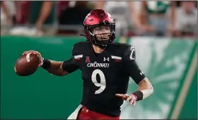  ?? (AP/Chris O’Meara) ?? Cincinnati quarterbac­k Desmond Ridder completed 31 of 39 for 304 yards and 2 touchdowns during the No. 5 Bearcats’ victory over South Florida on Friday night in Tampa, Fla.