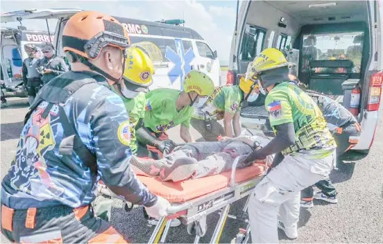  ?? PHOTOGRAPH COURTESY OF CAAP ?? MEMBERS of the Provincial Disaster Risk Reduction and Management Office participat­e in the full-scale emergency drill at the Tacloban Airport where organizers staged an aircraft fire simulation.