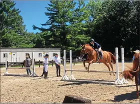  ?? NEWS-HERALD FILE ?? A rider practices a jump in 2018at the Chagrin Hunter Jumper Classic at the Cleveland Metroparks Polo Field in Moreland Hills. The 2020editio­n of the equestrian event has been canceled because of threats posed by the novel coronaviru­s pandemic.