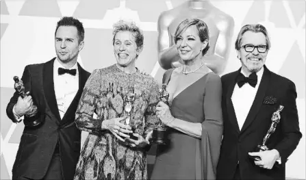  ?? JORDAN STRAUSS THE ASSOCIATED PRESS ?? Sam Rockwell, left, won best performanc­e by an actor in a supporting role for "Three Billboards Outside Ebbing, Missouri", Frances McDormand, won for best performanc­e by an actress in a leading role for "Three Billboards Outside Ebbing, Missouri",...