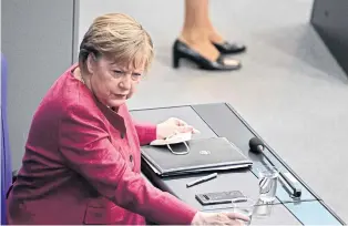  ?? AFP ?? German Chancellor Angela Merkel attends a session of the Bundestag yesterday in Berlin.