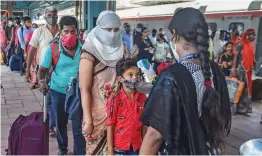  ?? — PTI ?? A BMC health worker conducts thermal screening of a child passenger for a Covid-19 test at Dadar railway station in Mumbai on Thursday.