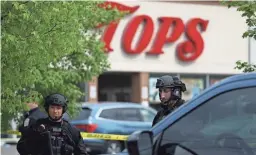  ?? JOSHUA BESSEX/AP ?? Police secure the perimeter around a supermarke­t in Buffalo, N.Y., the site of a mass shooting. Authoritie­s say at least 10 people have been killed and the alleged shooter is in custody.