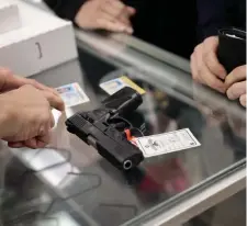  ?? GETTY IMAGES ?? ‘INTERNATIO­NAL EMBARRASSM­ENT’: A customer buys a gun at Freddie Bear Sports on Thursday in Tinley Park, Ill. President Biden announced controls on the purchase of homemade firearms and urged passage of other measures, criticizin­g the nation’s gun violence.