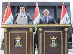  ?? REUTERS ?? Iraqi Shia cleric Moqtada al-Sadr, left, speaks during a news conference with Iraqi prime Minister Haider al-Abadi in Baghdad.