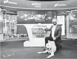  ?? COURTESY OF NASDAQ ?? Ron Coughlin, Petco CEO, with his dog, Yummy, a yellow Labrador retriever, participat­es in the Jan. 14 Nasdaq opening bell ceremony at the exchange’s MarketSite venue in Times Square.