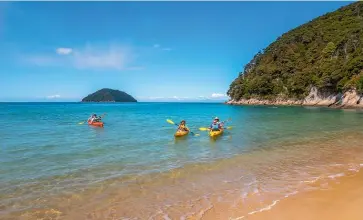  ?? KAITERITER­I KAYAK ?? Kayakers at tranquil Onetahuti Bay in the national park.