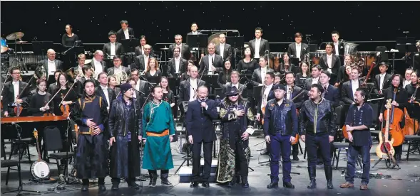  ?? PROVIDED TO CHINA DAILY ?? Tan Dun (center) and the rock band Hanggai stage a concert in Macao in December 2016.