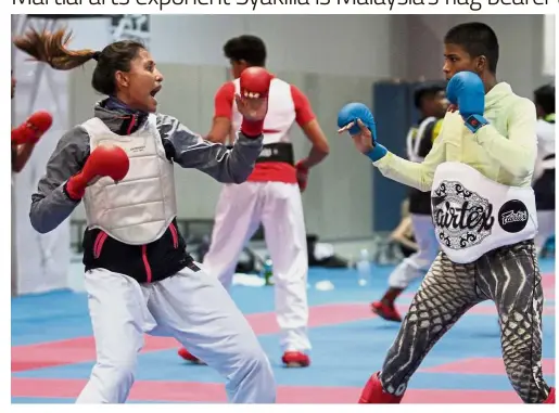  ??  ?? Leading the team: Karate exponent Syakilla Salni Jefry Krisnan (left), a gold medallist at the Icheon Asian Games in 2014, will be Malaysia’s flag bearer at next month’s Asian Games in Indonesia.