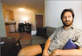  ?? Genaro Molina Los Angeles Times ?? MUKESH KULRIYA, 33, a PhD student at UCLA, sits in his Culver City apartment. When he first came to L.A. in 2018, he had a stressful time finding housing.
