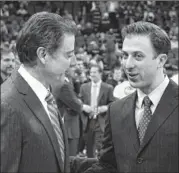  ??  ?? Louisville coach Rick Pitino (left) shakes hands with his son Richard Pitino before dad’s team beat his son’s Florida Internatio­nal team 79-55 on Wednesday. It was their first head-to-head coaching matchup.