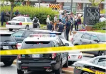  ?? AP PHOTO BY JOSE LUIS MAGANA ?? Authoritie­s stage at the office building entrance after multiple people were shot at The Capital Gazette newspaper in Annapolis, Md., on Thursday.