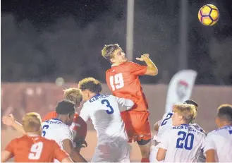  ?? ROBERTO E. ROSALES/JOURNAL ?? New Mexico’s Matthew Constant (19) tries a header Saturday night against visiting Kentucky. The 13th-ranked Wildcats won 1-0, ending UNM’s 14-game home unbeaten streak.