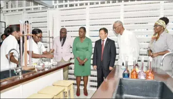  ??  ?? President David Granger (second from right), China’s Ambassador to Guyana Cui Jianchun (third from right), Minister of Education Dr. Nicolette Henry (second from left), Chief Education Officer, Dr. Marcel Hutson (left) and Principal CPCE, Viola Rowe look on as students conduct an experiment. (Ministry of the Presidency photo)