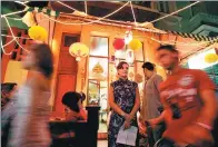  ?? VIA ASSOCIATED PRESS ?? A woman stands in front a Chinese restaurant as she waits for customers during Chinese New Year celebratio­ns in Havana’s Chinatown district.