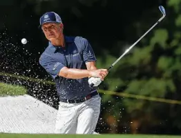  ??  ?? David Toms blasts out of a greenside bunker on No. 9. Toms wound up tied for second place, two shots behind winner Mike Weir.