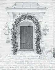  ?? Julie Soefer ?? Designer Regina Gust used pine and magnolia for the front door of this spare, crisply decorated home.