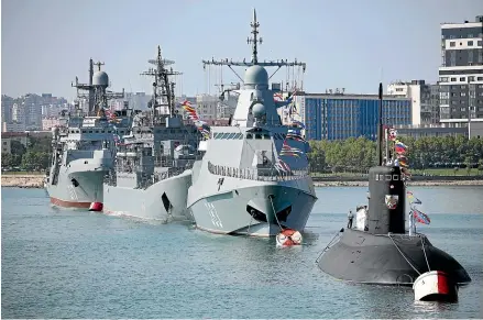  ?? AP ?? Warships go on parade during the Navy Day celebratio­n in Novorossiy­sk, Russia.