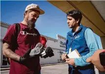  ?? Jon Shapley/Staff photograph­er ?? Dr. Mudit Gilotra, right, assistant medical director of Healthcare for the Homeless-Houston, talks with Larry Taylor Jr. about his health after he approached the medical outreach team.