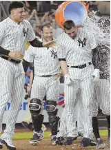 ?? AP PHOTO ?? WALKER-OFF: Neil Walker (right) is doused with water after hitting a game-winning homer in the Yankees’ 5-4 victory against the Chicago White Sox in New York.