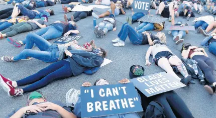  ?? AP ?? Protesters lie silent for 8 minutes and 46 seconds on Friday, June 5, during a demonstrat­ion to honour George Floyd, near the home of Sacramento Mayor Darrell Steinberg in Sacramento, California. Floyd, a black man, died after being restrained by Minneapoli­s police officers on May 25.