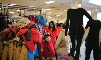  ?? (Chris Helgren/Reuters) ?? SHOPPERS LOOK at winter coats on the first day of liquidatio­n sales at a Sears department store in Mississaug­a, Ontario, last month. Canadian retailers risk missing out on strong consumer demand at a time of economic prosperity and ending up with a...