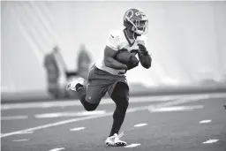  ?? Associated Press ?? Washington Redskins running back Samaje Perine (32) runs with the ball during NFL football rookie minicamp Saturday in Ashburn, Va.