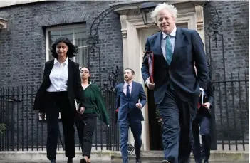  ?? — AFP file photo ?? Johnson (right) leaves 10 Downing Street in London with Mirza (left) to attend a weekly cabinet meeting at the nearby Foreign, Commonweal­th and Developmen­t Office.