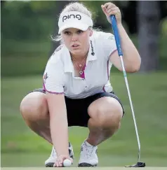  ?? TOM PENNINGTON/GETTY IMAGES ?? Brooke Henderson lines up a putt on the seventh green at the North Texas Shootout at Las Colinas Country Club on Friday in Irving, Texas. She leads the pack at 8-under.