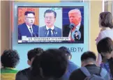  ?? AHN YOUNG-JOON/ASSOCIATED PRESS ?? People watch a screen showing N. Korean leader Kim Jong Un, left, S. Korean President Moon Jaein and President Donald Trump at the Seoul Railway Station in S. Korea, earlier this week.