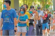  ?? AP PHOTO/VINCENT YU ?? People queue up to vote in Hong Kong on Sunday in an unofficial primary for pro-democracy candidates ahead of legislativ­e elections in September.