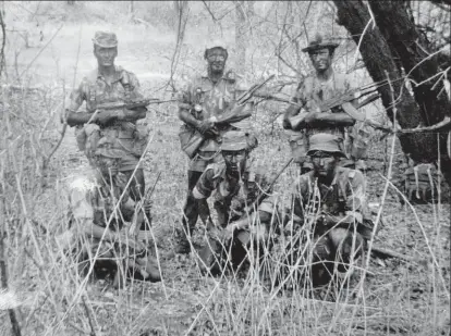  ??  ?? Clockwise from above: Michael Graham’s SAS unit; Frelimo terrorists pose with a KPV 14.5mm antiaircra­ft gun; mooring the kayaks after the 353km journey; Michael Graham poses with a camera in his SAS days; a well-earned rest.