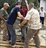  ?? CHRISTIAN FRIENDS OF KOREA ?? Visiting volunteers from the U.S.-based aid group, Christian Friends of Korea, and local staff repair a water pump at the Haeju TB Rest Home, South Hwanghae province, North Korea, in 2017.