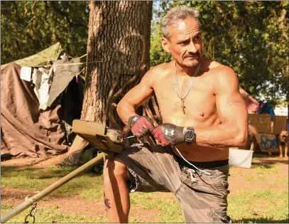  ?? PHOTOS BY MATT BATES — ENTERPRISE-RECORD ?? Pedro Martinez gets ready to do some yard work Monday around his tent at Comanche Creek Greenway in Chico. Martinez said he moved to Comanche Creek about two months ago after being removed from the Pine and Cypress streets grassy area.