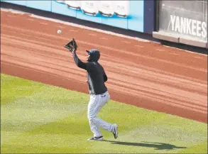  ?? Kathy Willens / Associated Press ?? New York Yankees infielder Miguel Andujar fields a fly ball in the outfield during a baseball summer training camp workout on Sunday at Yankee Stadium in New York.