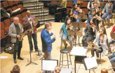  ?? TIM TAI/PHILADELPH­IA INQUIRER ?? The Temple Studio Orchestra rehearses in the school’s performing arts center in North Philadelph­ia pre-pandemic, in 2019. Composer Vince Mendoza, in blue, led the rehearsal of his compositio­n “Constant Renaissanc­e,”with featured soloists Terell Stafford, second from left, and Dick Oatts, left.