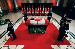  ?? CP PHOTO JUSTIN TANG ?? Sentinels surround the casket of former prime minister Brian Mulroney as he lies in state at the Sir John A. Macdonald Building, across from Parliament Hill in Ottawa, on Tuesday.