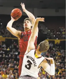  ?? Matt York / Associated Press ?? Stanford forward Reid Travis, who scored 24 points, shoots over Arizona State forward Mickey Mitchell in the first half.