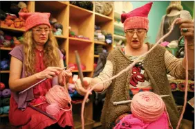  ?? REUTERS ?? Molly Cleator (R) takes part in the Pussyhat social media campaign to provide pink hats for protesters in the women’s march in Washington, D.C., the day after the presidenti­al inaugurati­on, in Los Angeles, California, on Friday.