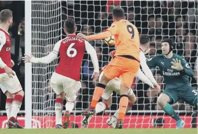  ??  ?? Roberto Firmino (9) pounces to get Liverpool back to 3-3 in last night’s sensationa­l Premier League clash at Arsenal.