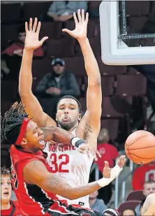  ?? [BROOKE LAVALLEY/DISPATCH] ?? Ohio State center Trevor Thompson blocks the way as Khalil Batie of Rutgers tries to pass the ball during a game on Feb. 8. Thompson has struggled with foul trouble in recent games.