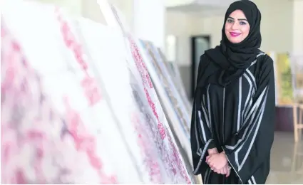  ?? Photos Reem Mohammed / The National ?? Safia Al Mahrizi, a project manager at the Roads and Transport Authority, decided to create her calligraph­ic artwork of poems because she was inspired by Sheikh Mohammed bin Rashid’s poetry and his efforts to promote reading.