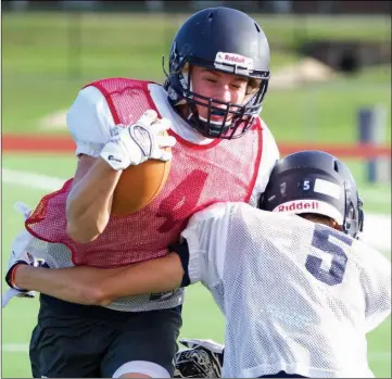  ??  ?? Conway Christian junior Brandon Shaw, No. 5, tries to tackle sophomore Wyatt Lawrence during a scrimmage.